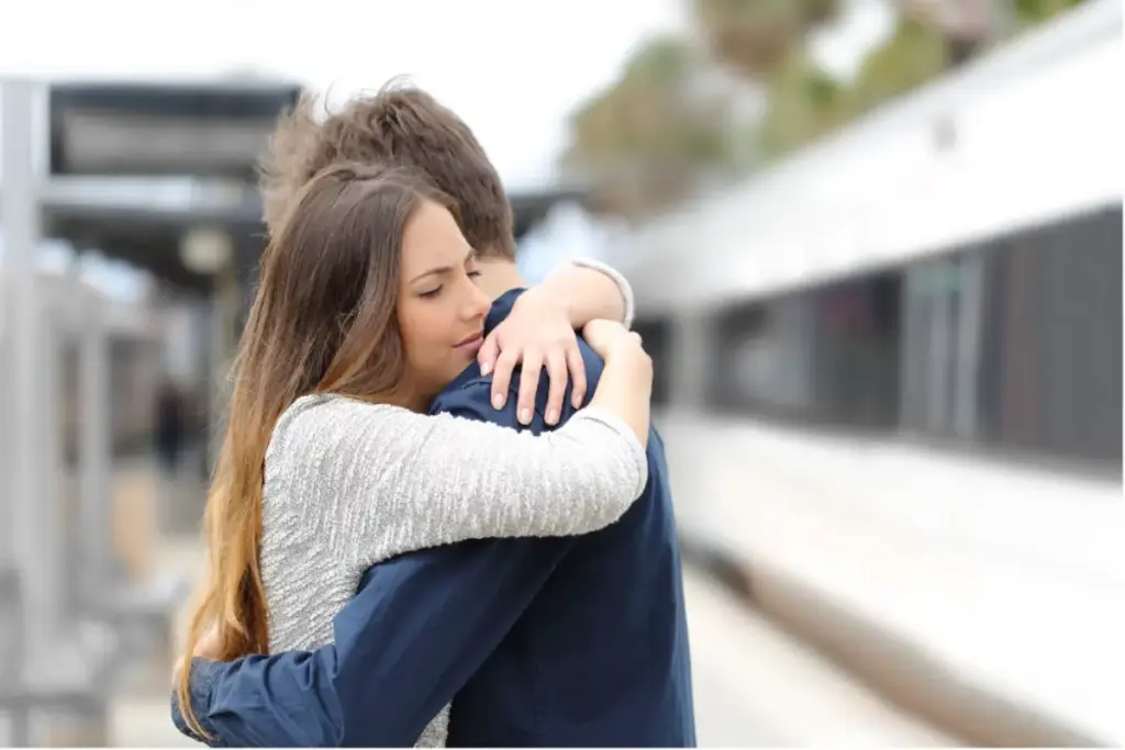 Couple hugging during a comfortable flight while traveling with luxury travel assistance for addiction treatment