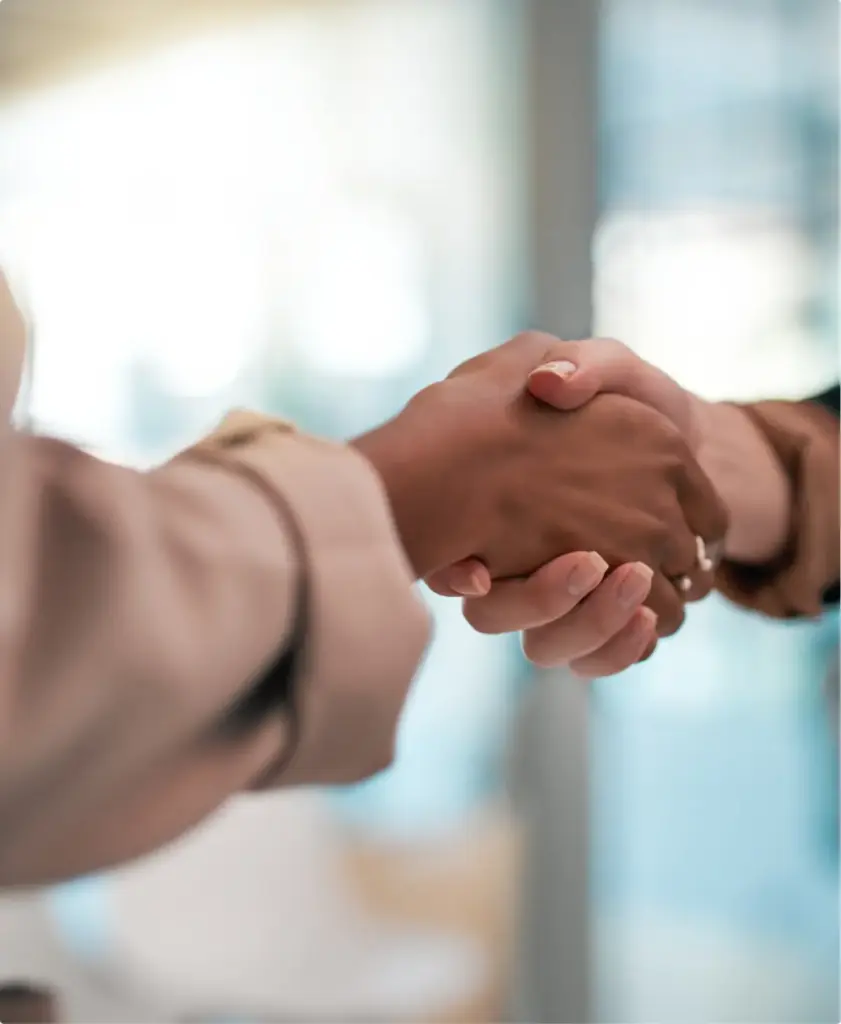 Therapist and client shaking hands during outpatient rehab program meeting