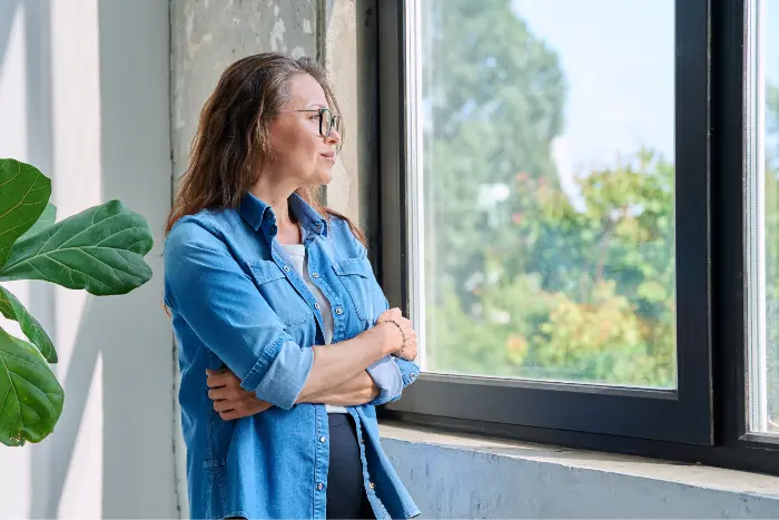 Woman reflecting during recovery journey in a holistic and clinical addiction treatment setting