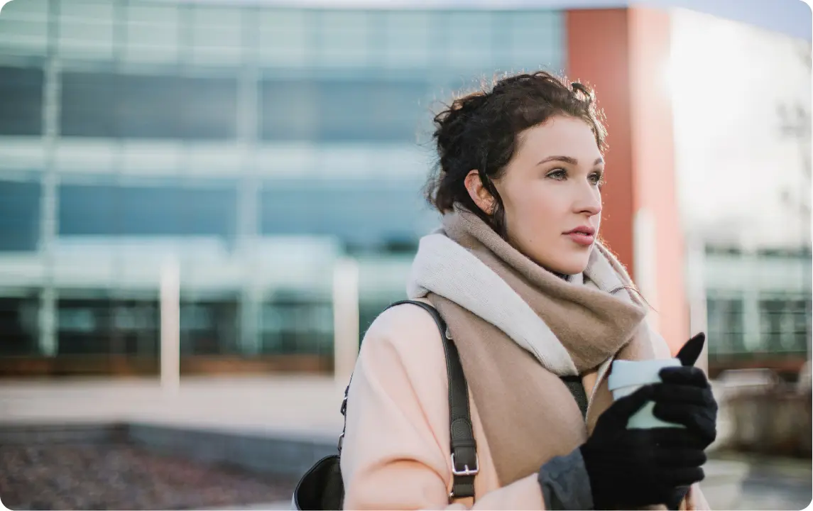 A focused professional woman in a city setting, representing the successful reintegration and clinical support provided by an Intensive Outpatient Program.
